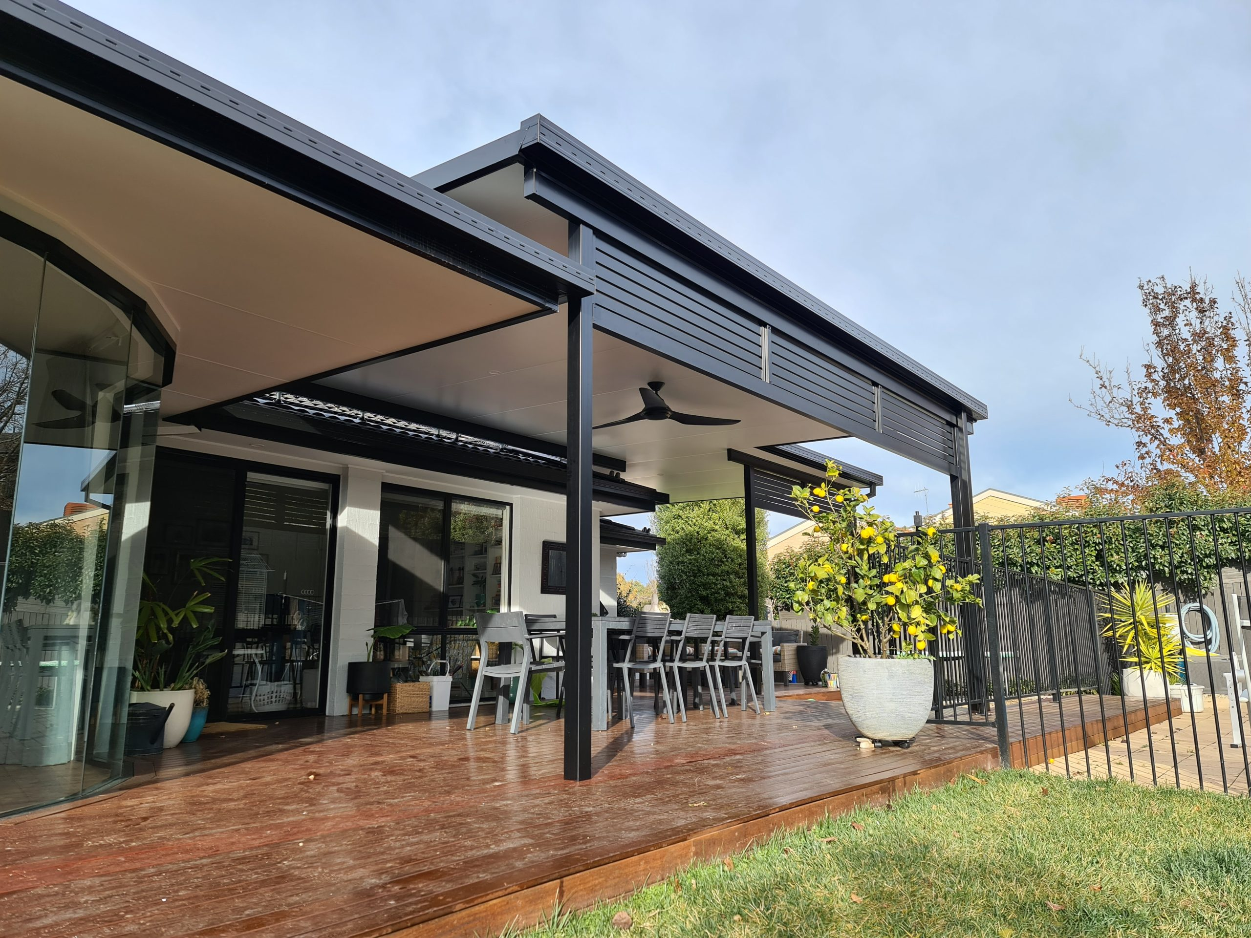 a home with an insulated roof and outdoor dining area.
